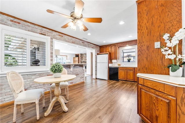 12172 Manley St, Garden Grove, CA 92845 - kitchen featuring freestanding refrigerator, black dishwasher, brown cabinets, a ceiling fan, and light countertops