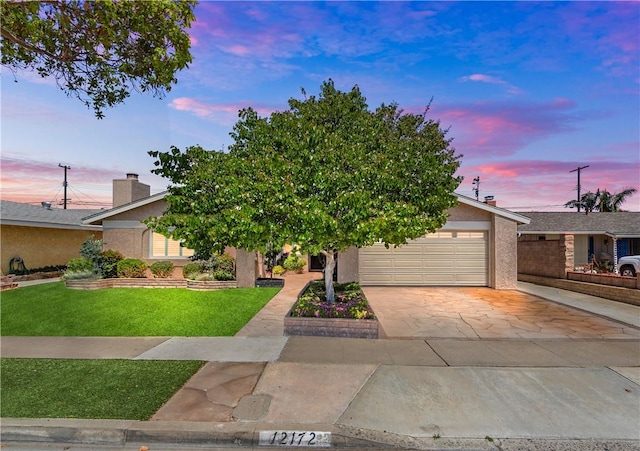 12172 Manley St, Garden Grove, CA 92845 - view of front of house with a front lawn, driveway, stucco siding, and a garage