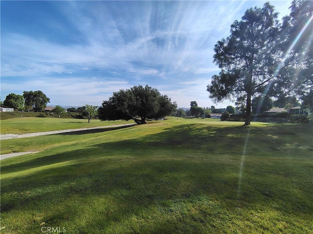view of home's community featuring a yard and golf course view