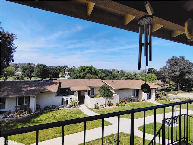 view of front of home featuring a front lawn, stucco siding, and a residential view