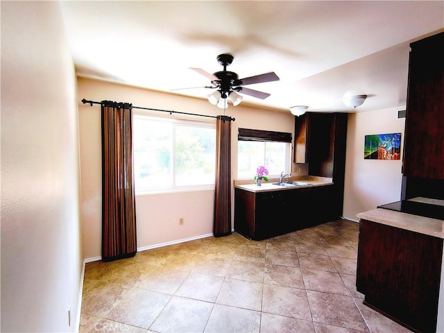 26373 Oak Highland Dr Unit E, Newhall, CA 91321 - kitchen featuring ceiling fan, light countertops, light tile patterned floors, and dark brown cabinets