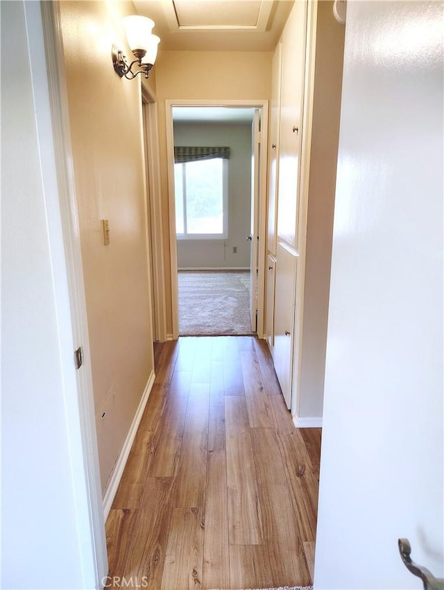 26373 Oak Highland Dr Unit E, Newhall, CA 91321 - corridor featuring light wood-type flooring and attic access