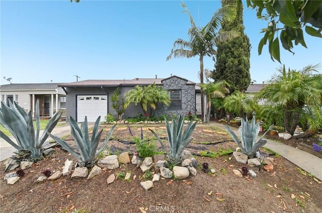 view of front of home with a garage and stucco siding