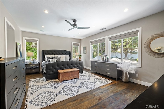 bedroom with multiple windows, baseboards, dark wood-style flooring, and recessed lighting