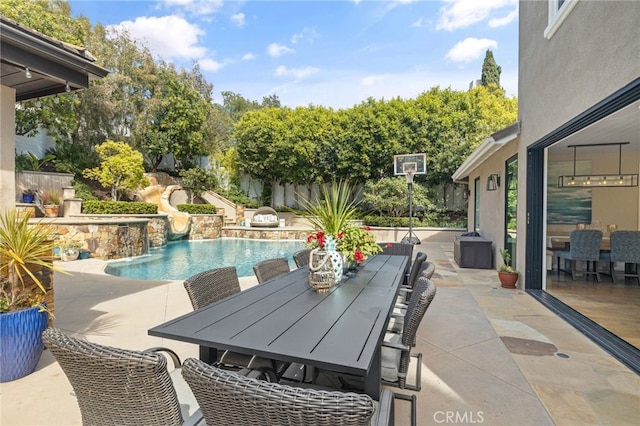 view of swimming pool featuring a patio, a water slide, and outdoor dining area