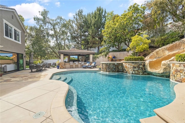 view of swimming pool featuring a gazebo, fence, and a patio area