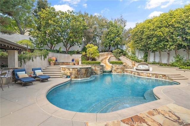 view of swimming pool featuring an in-ground hot tub, a fenced backyard, and a patio