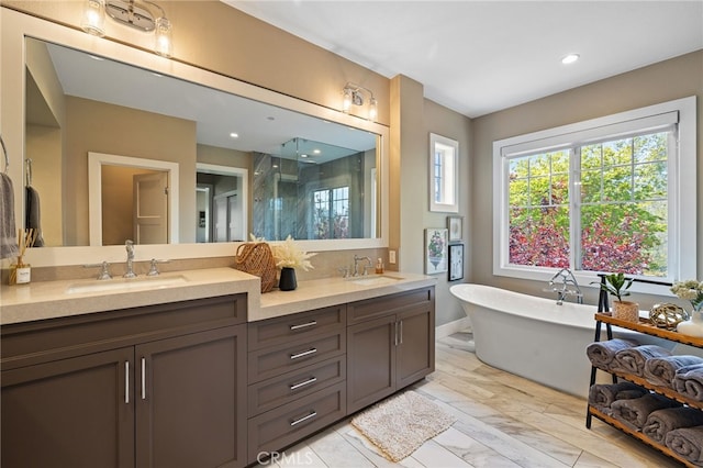 bathroom with a shower stall, double vanity, a soaking tub, and recessed lighting