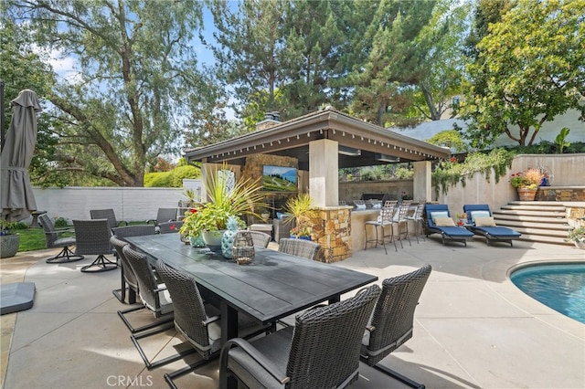 view of patio featuring a fenced backyard, a gazebo, and outdoor dining area