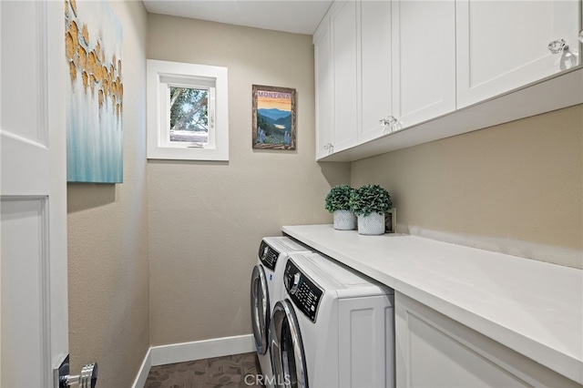 laundry room with cabinet space, washer and clothes dryer, and baseboards