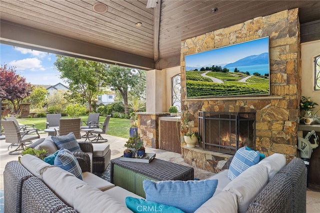 view of patio / terrace featuring an outdoor living space with a fireplace and fence
