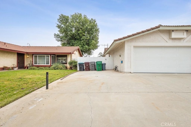25283 Menominee Ct, Moreno Valley, CA 92553 - view of front of home with driveway, a tile roof, a garage, stucco siding, and a front lawn