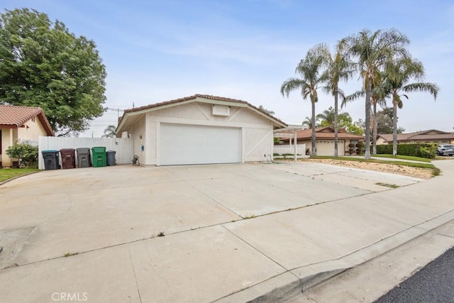 25283 Menominee Ct, Moreno Valley, CA 92553 - view of front facade featuring driveway, stucco siding, a tiled roof, and fence