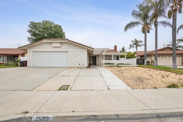 25283 Menominee Ct, Moreno Valley, CA 92553 - single story home featuring an attached garage, concrete driveway, stucco siding, and a tiled roof