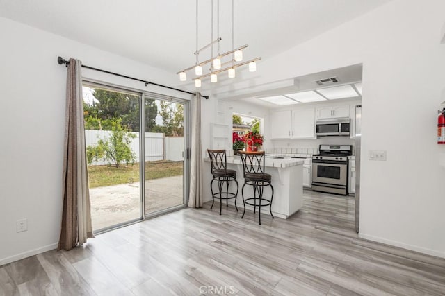 25283 Menominee Ct, Moreno Valley, CA 92553 - dining room featuring baseboards, light wood-style floors, and visible vents