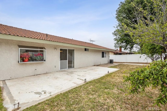 25283 Menominee Ct, Moreno Valley, CA 92553 - back of property featuring central air condition unit, fence, a patio area, a tile roof, and stucco siding