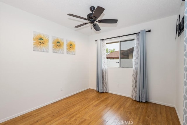 25283 Menominee Ct, Moreno Valley, CA 92553 - empty room with light wood finished floors, baseboards, and a ceiling fan