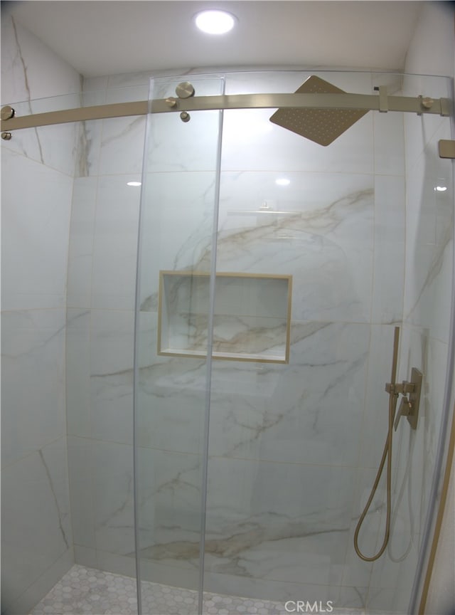 bathroom with a marble finish shower