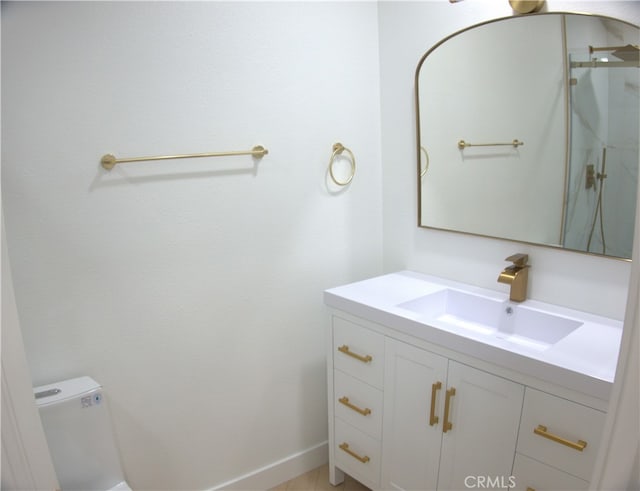 bathroom featuring an enclosed shower, toilet, and vanity