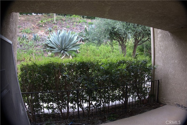 exterior space with stucco siding and fence