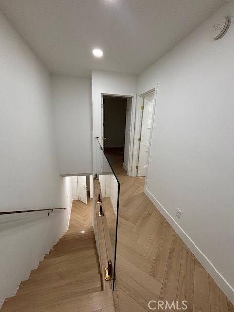 staircase with baseboards and recessed lighting
