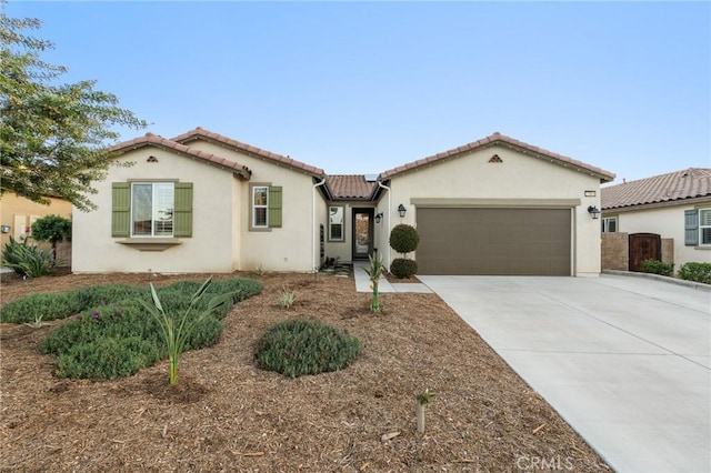 22811 Rolling Brook Ln, Wildomar, CA 92595 - mediterranean / spanish home featuring a garage, stucco siding, driveway, and a tiled roof