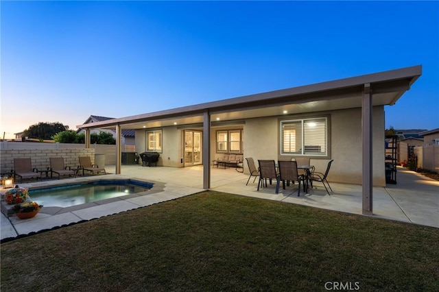 22811 Rolling Brook Ln, Wildomar, CA 92595 - back of property at dusk featuring stucco siding and a patio