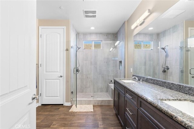 22811 Rolling Brook Ln, Wildomar, CA 92595 - bathroom with double vanity, a stall shower, and wood finished floors