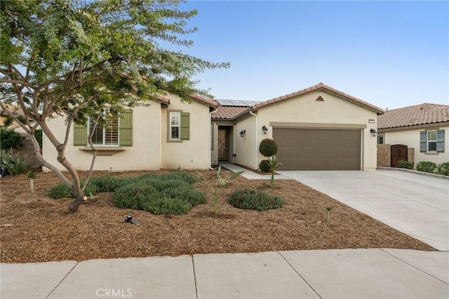 22811 Rolling Brook Ln, Wildomar, CA 92595 - mediterranean / spanish home featuring solar panels, a garage, concrete driveway, a tiled roof, and stucco siding