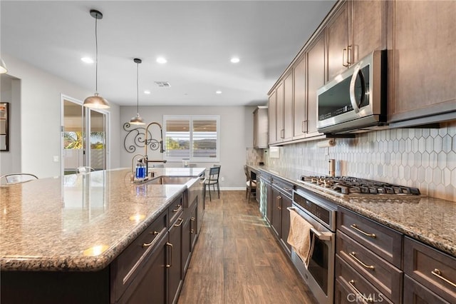 22811 Rolling Brook Ln, Wildomar, CA 92595 - kitchen featuring appliances with stainless steel finishes, dark wood-style floors, backsplash, light stone countertops, and recessed lighting