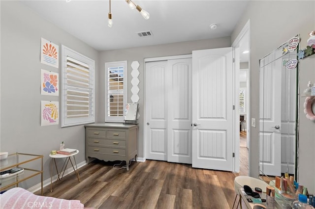 22811 Rolling Brook Ln, Wildomar, CA 92595 - bedroom featuring dark wood-style flooring, multiple windows, baseboards, and a closet