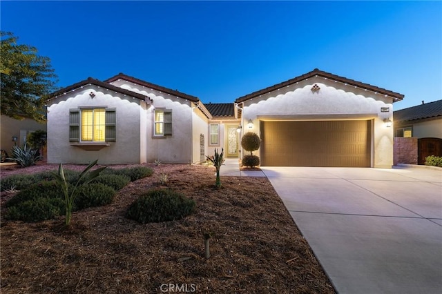 22811 Rolling Brook Ln, Wildomar, CA 92595 - mediterranean / spanish-style house featuring driveway, stucco siding, and an attached garage