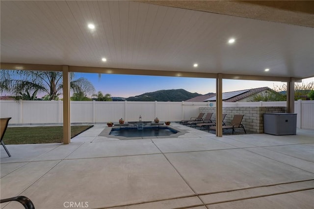 22811 Rolling Brook Ln, Wildomar, CA 92595 - patio terrace at dusk with a patio, a fenced backyard, and a mountain view