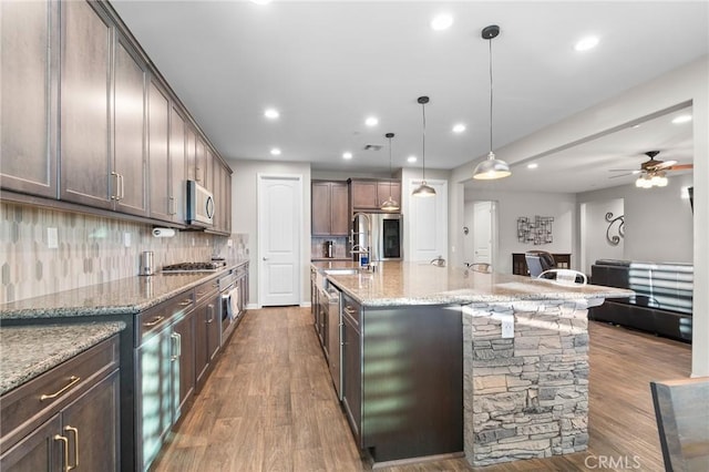 22811 Rolling Brook Ln, Wildomar, CA 92595 - kitchen with stainless steel appliances, ceiling fan, dark wood finished floors, backsplash, and recessed lighting