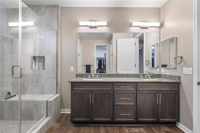 22811 Rolling Brook Ln, Wildomar, CA 92595 - full bath with wood finished floors, baseboards, a shower stall, and double vanity
