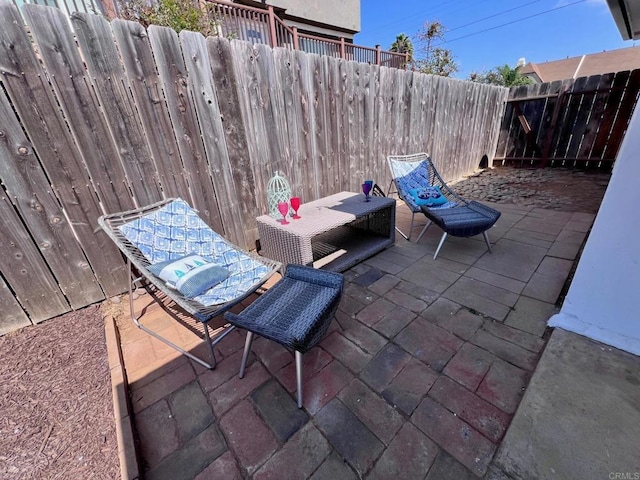 view of patio with outdoor dining space and a fenced backyard