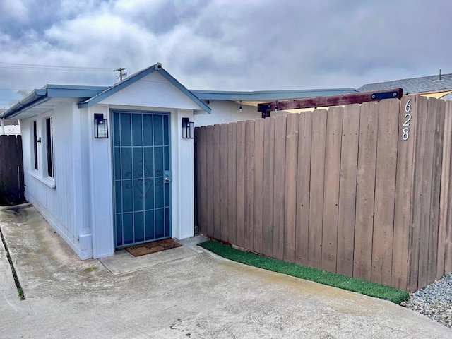 view of outbuilding with fence and an outdoor structure