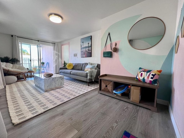 living room with baseboards and wood finished floors