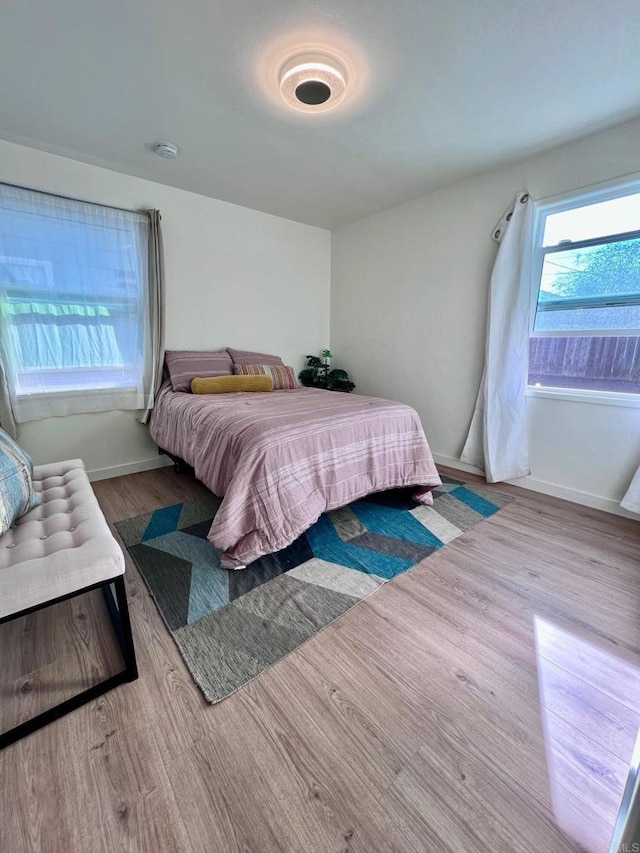 bedroom featuring baseboards and wood finished floors