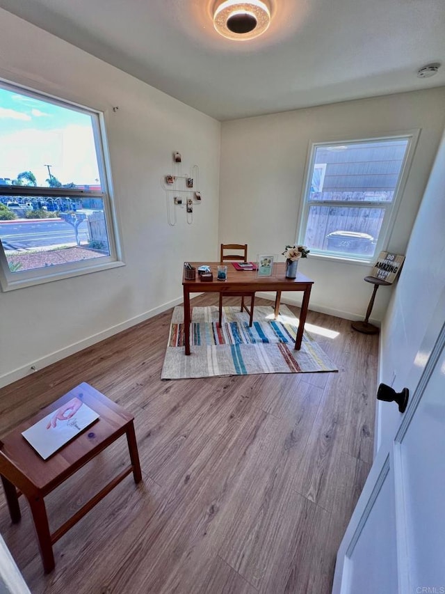 office space featuring baseboards and wood finished floors