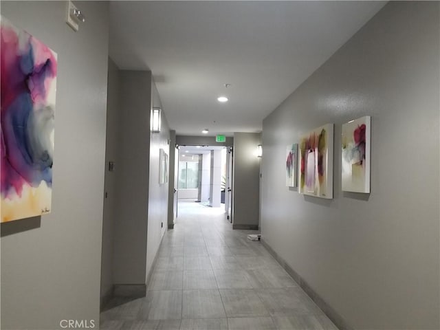 corridor with baseboards and recessed lighting