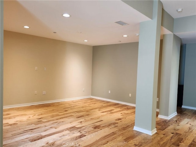 unfurnished room with light wood-type flooring, visible vents, baseboards, and recessed lighting