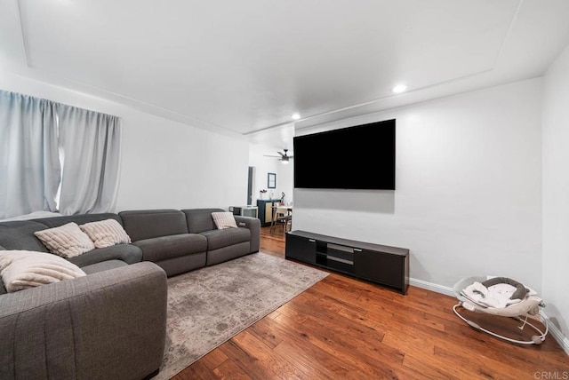 living room featuring wood finished floors, baseboards, and recessed lighting