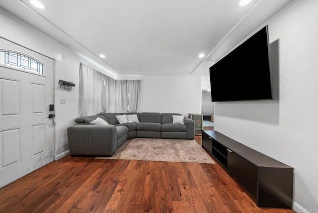 living room featuring baseboards, dark wood-type flooring, and recessed lighting