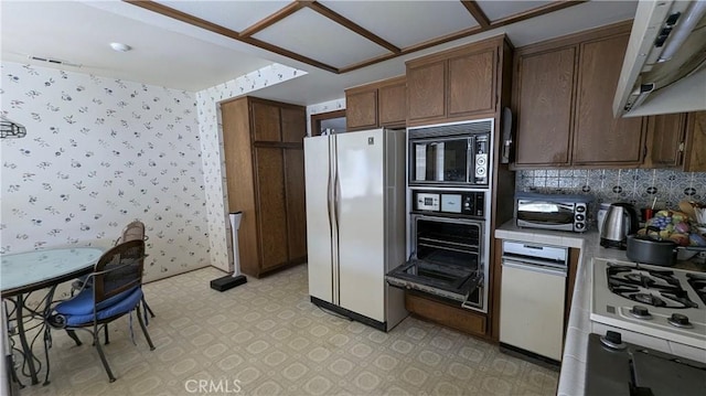 100 S Lucia Ave Unit 1, Redondo Beach, CA 90277 - kitchen with white appliances, light floors, wallpapered walls, light countertops, and tasteful backsplash