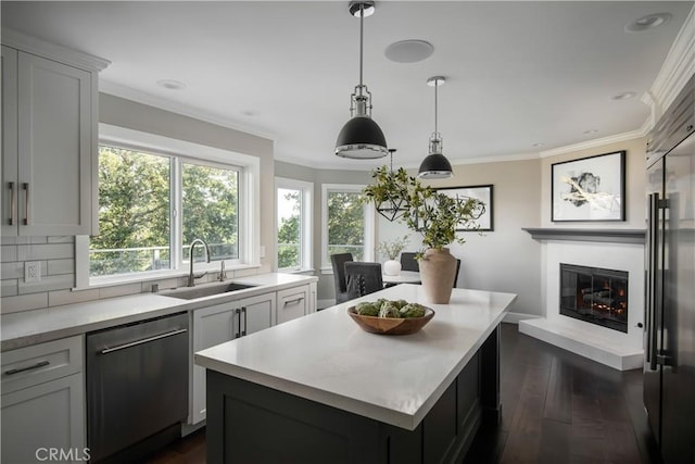 27417 Matterhorn Dr, Lake Arrowhead, CA 92352 - kitchen featuring stainless steel dishwasher, a glass covered fireplace, a sink, a kitchen island, and light countertops