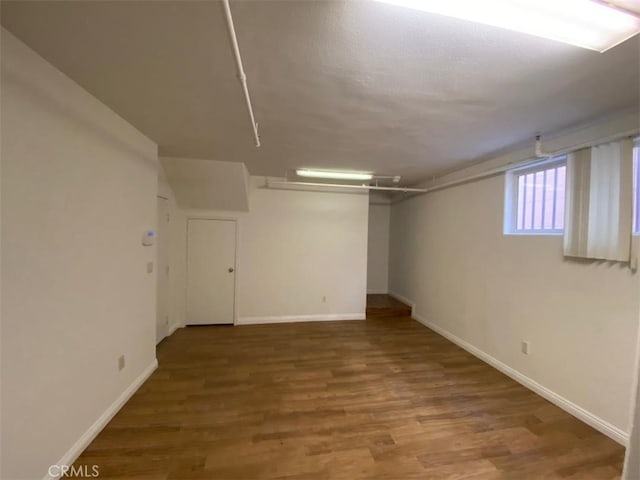 below grade area with wood finished floors and baseboards