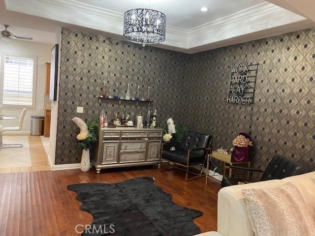 bedroom featuring recessed lighting, baseboards, ornamental molding, wood finished floors, and a raised ceiling