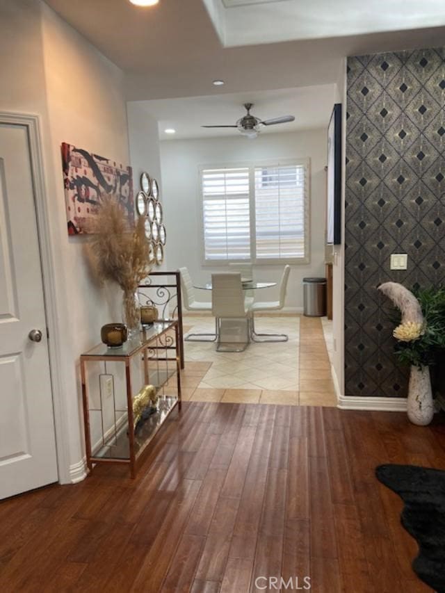 corridor featuring wood finished floors, baseboards, and recessed lighting