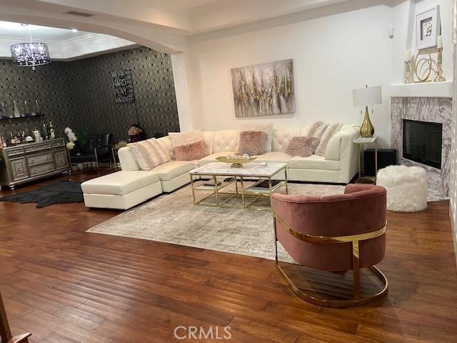 14535 Margate St Unit 12, Sherman Oaks, CA 91411 - living room featuring hardwood / wood-style floors, a chandelier, a fireplace, wallpapered walls, and arched walkways